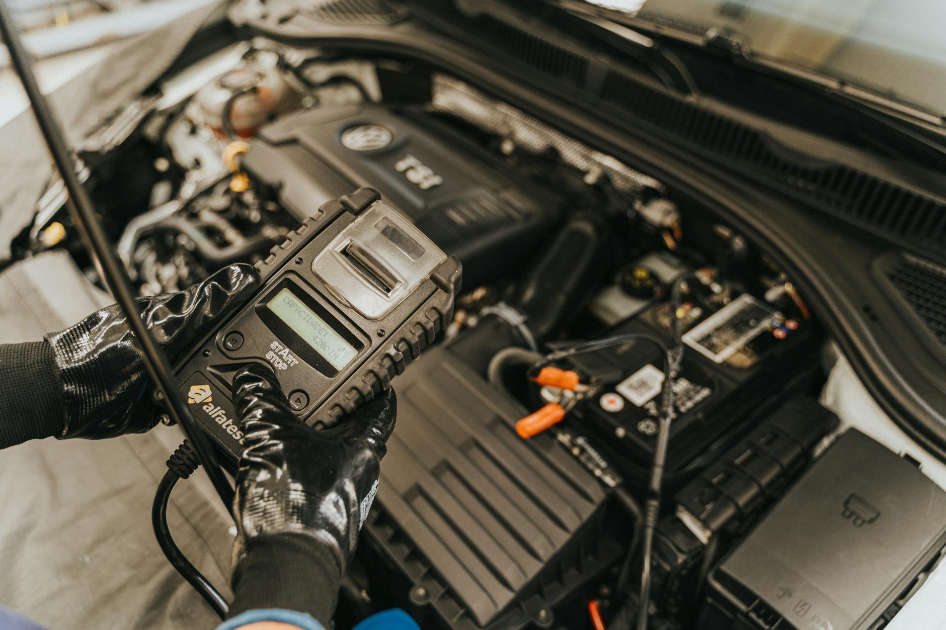 Technician working on engine bay — RD SUPPORT.